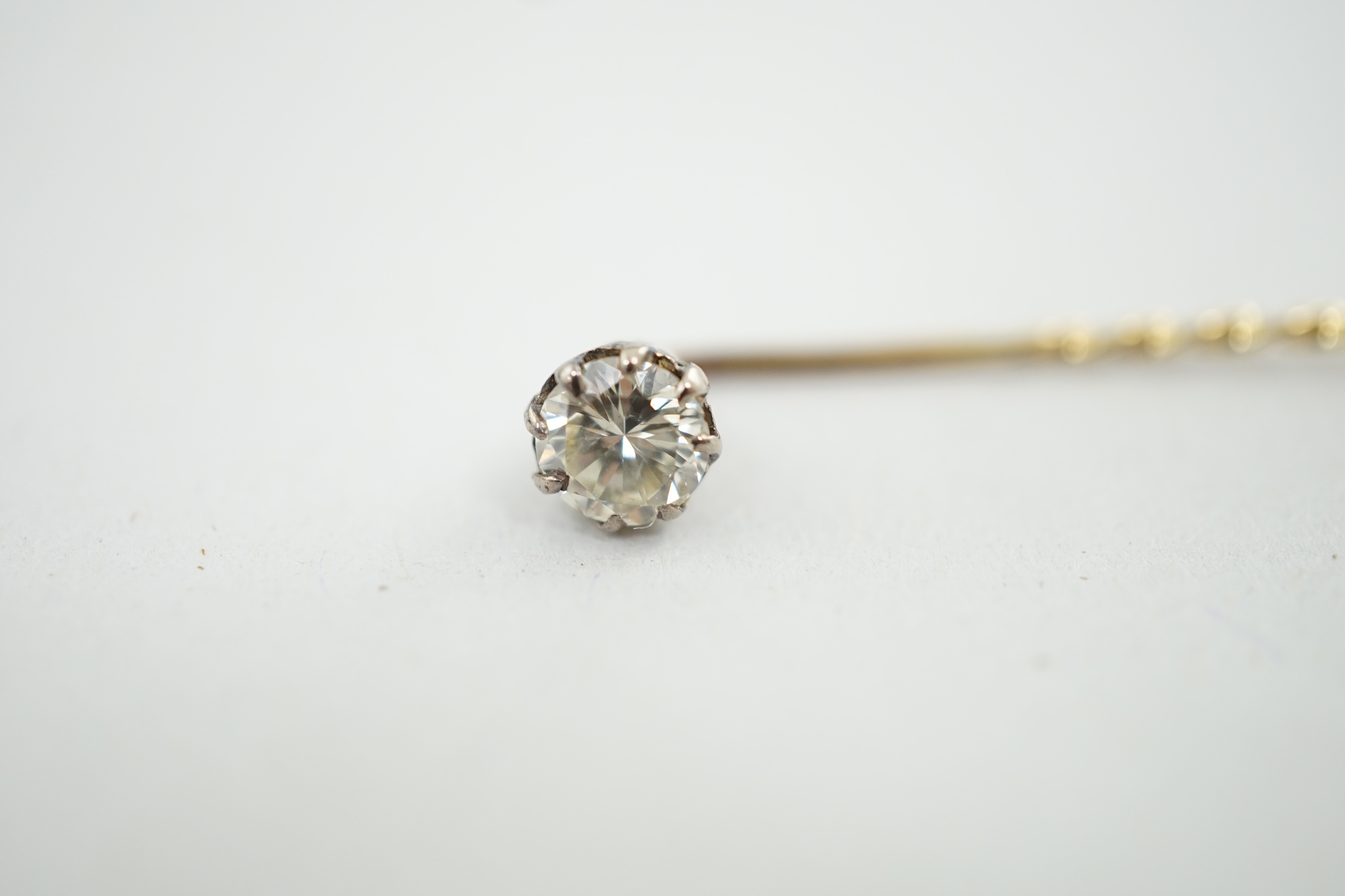 A late Victorian gold and solitaire diamond set stick pin